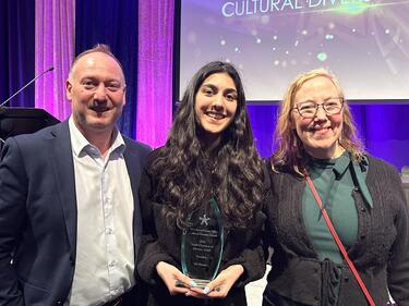 Superintendent Nosek and Chair Wilson, stand with Abby Schools student who won an award at the Cultural Diversity Awards