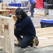Male student competing in carpentry competition